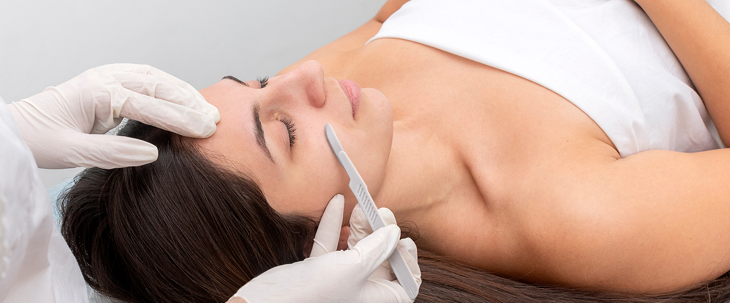 woman getting a dermaplaning treatment woman getting a dermaplaning treatment